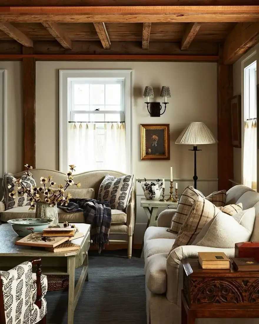 English cottage living room with layered textiles, fireplace and collected decor