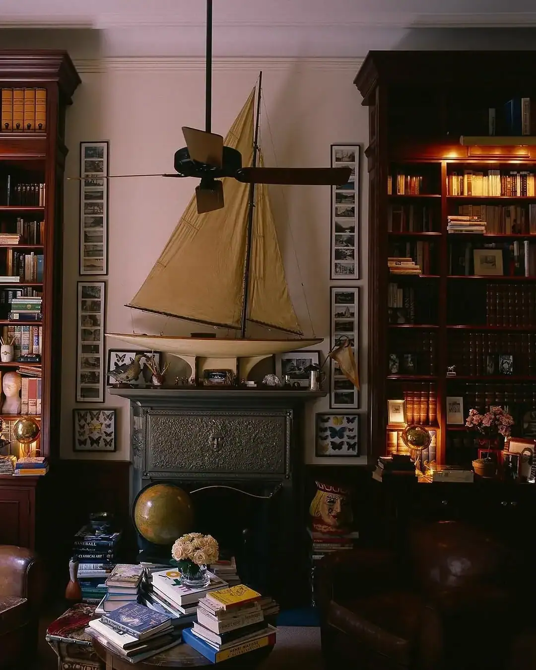 Dark academia vintage home library with warm wood built-ins, rolling ladder and layered shelves