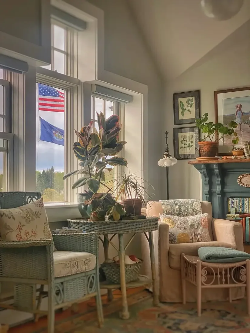 Vintage cottage living room with wicker furniture, floral textiles and soft light