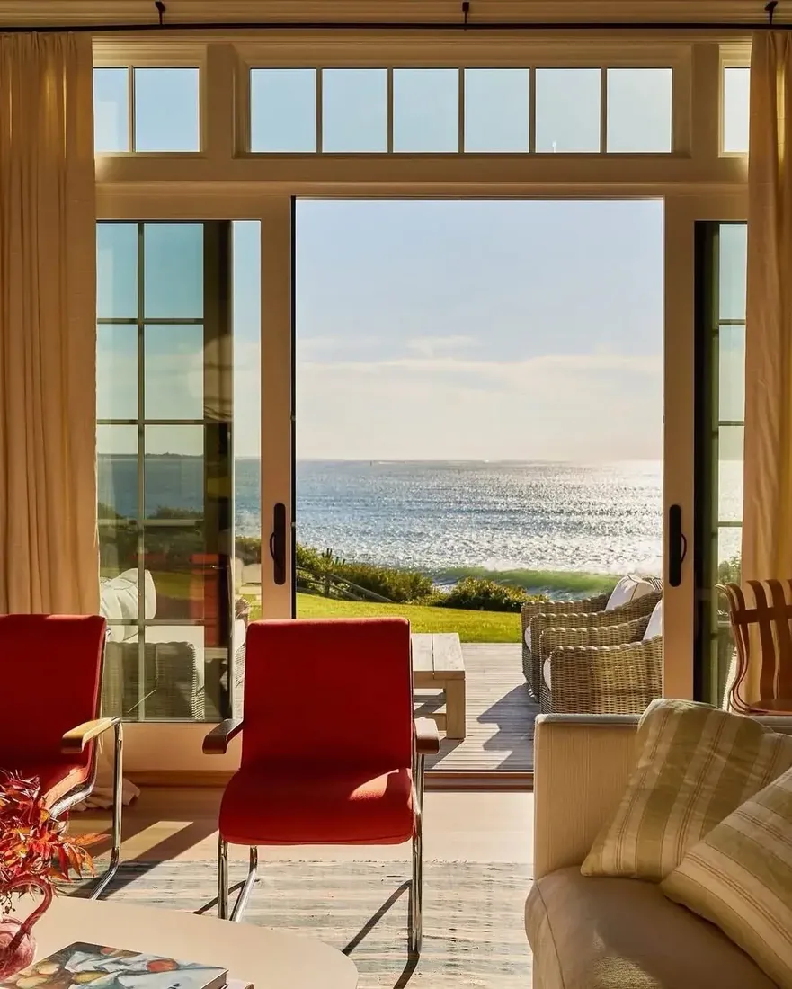Coastal living room with ocean view, white walls and deep blue textiles
