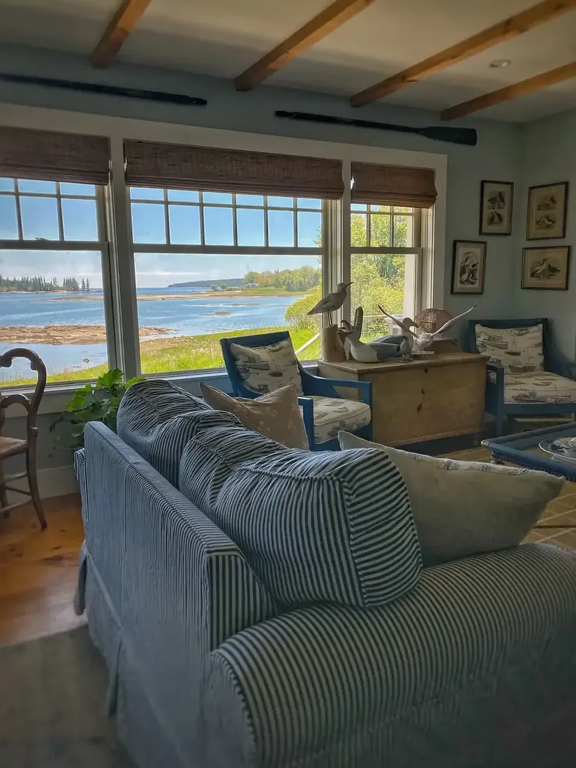Coastal living room with water view, low seating and deep blue accents