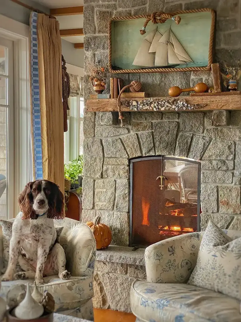 Coastal cottage living room with low seating, warm lighting and lake view beyond