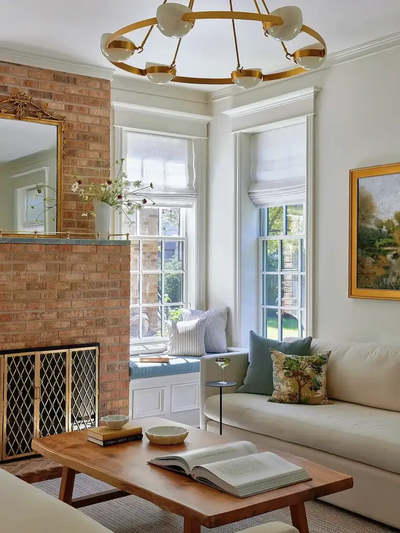 Brick fireplace with built-in window seat and soft cushions