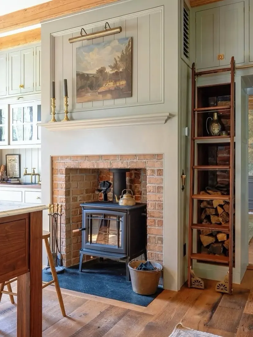 Cottage brick fireplace with wood stove insert and oak beam mantel