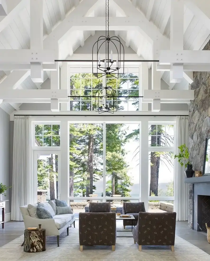 Modern living room with vaulted ceiling, soft textiles and warm lighting