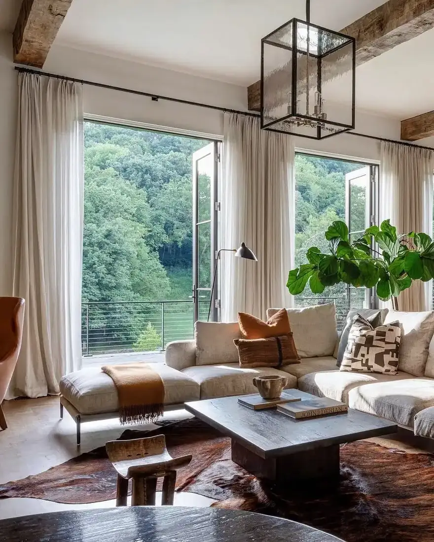 Modern living room with vaulted ceiling, timber beams and warm low lighting