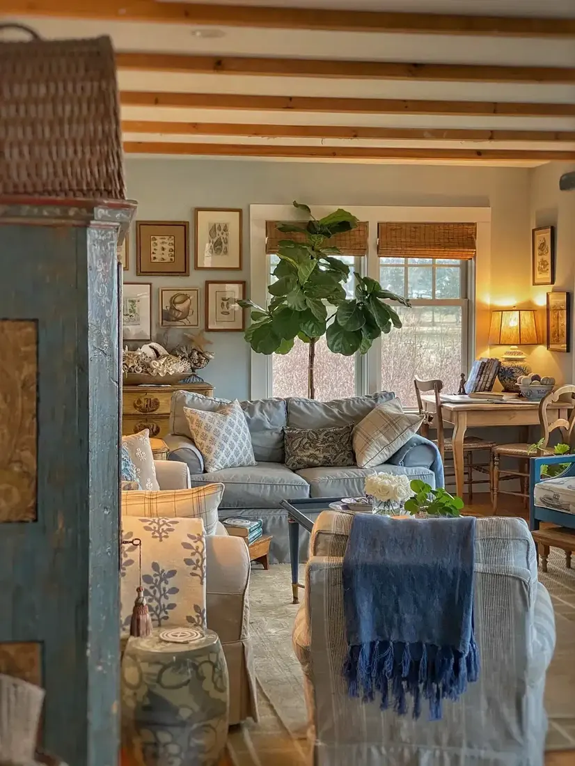 Rustic farmhouse living room with stone fireplace, timber mantel and layered textiles
