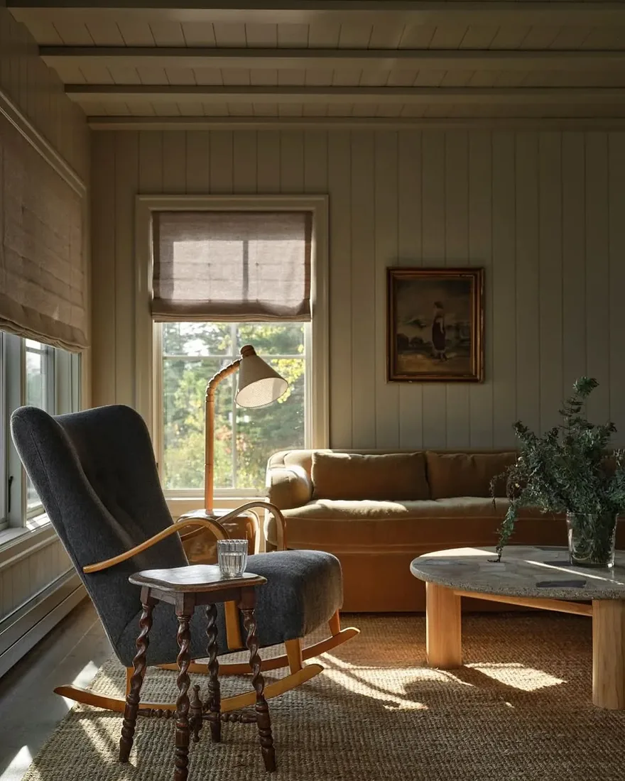 Minimalist cabin living room with jute rug, timber beams and plain linen sofa