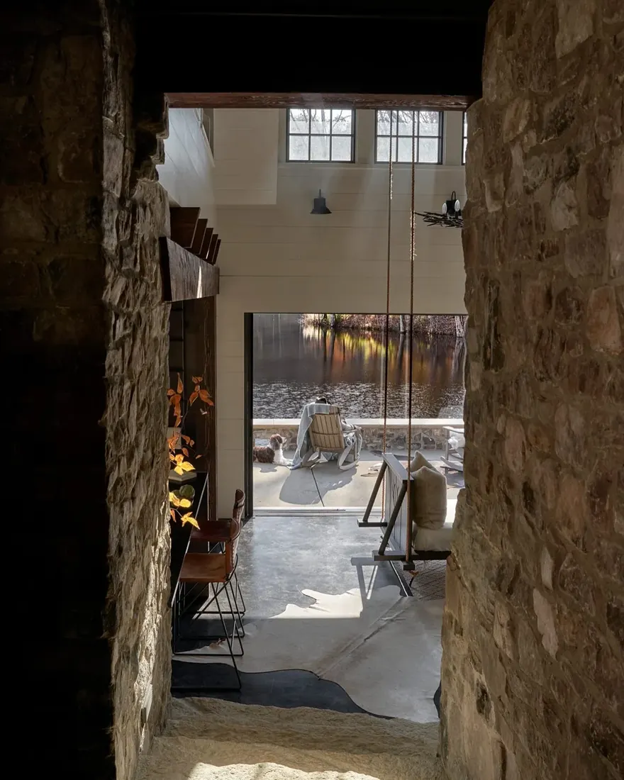 Modern stone archway living room with timber beams and soft furnishings