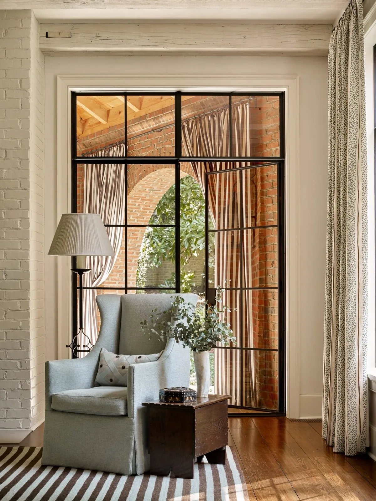 Elegant reading nook framed by a black window