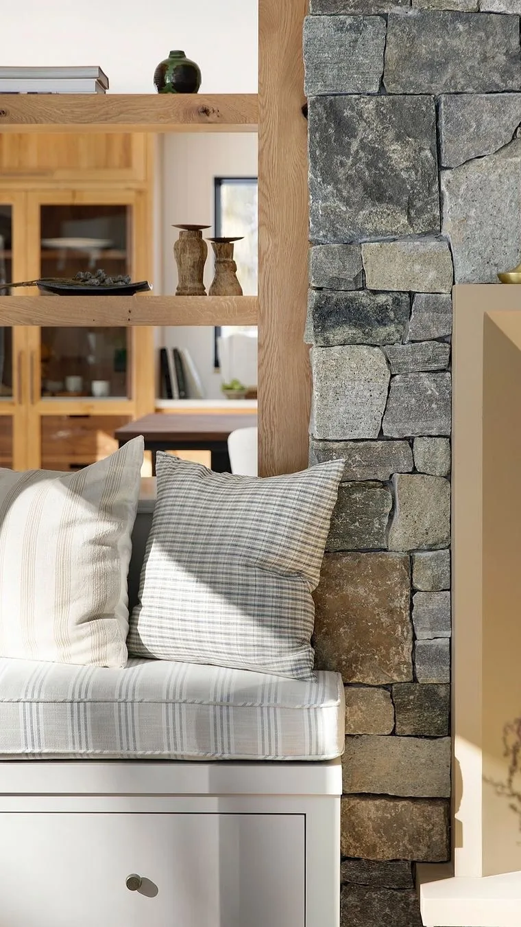 Rustic stone wall window seat with cushions