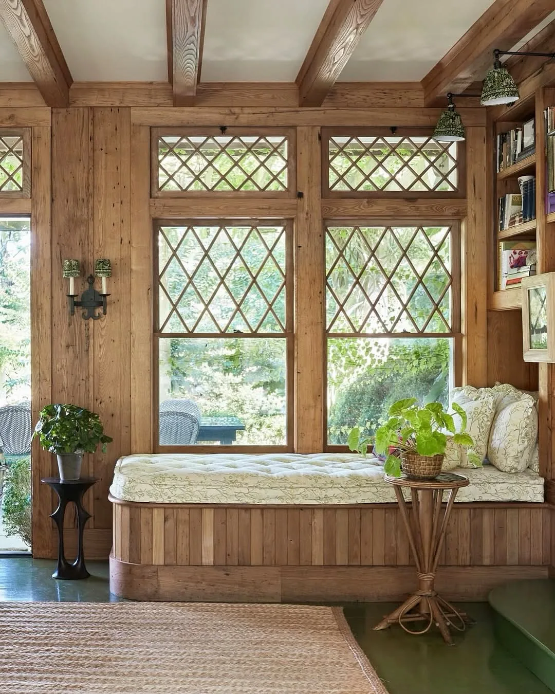 Rustic wood sunroom window seat with plants