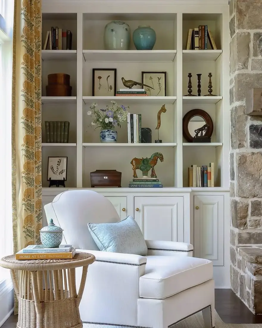White built-in shelves set against stone wall with breathing room